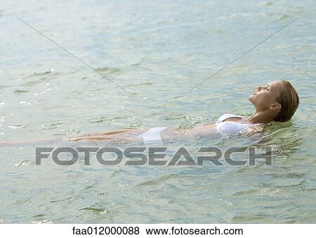 Woman relaxing in shallow water View Large Photo Image Stock Photo - Woman relaxing in shallow water. Fotosearch