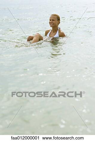 Woman sitting in shallow water View Large Photo Image Stock Image - Woman sitting in shallow water. Fotosearch