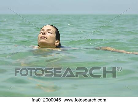 Woman swimming in sea View Large Photo Image Stock Photograph - Woman swimming in sea. Fotosearch