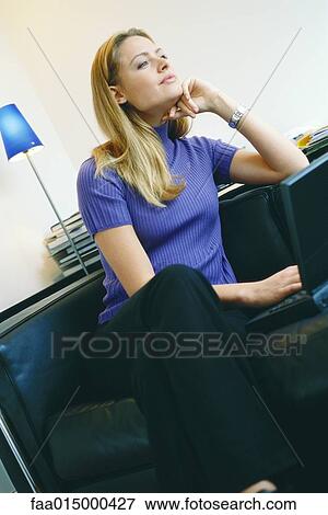 Woman using laptop, looking away View Large Photo Image Stock Photo - Woman using laptop, looking away. Fotosearch