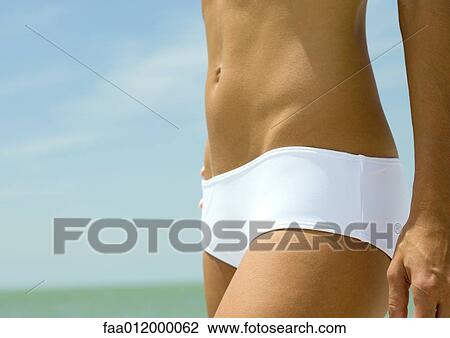 Woman wearing bikini near sea, close-up of abdomen View Large Photo Image Stock Image - Woman wearing bikini near sea, close-up of abdomen. Fotosearch