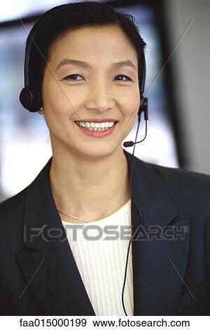 Stock Photo - Woman wearing headset, portrait. Fotosearch