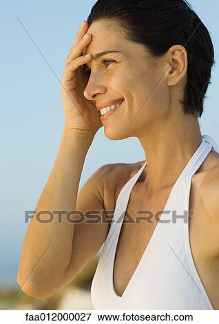 Woman with hand covering part of face, side view, portrait View Large Photo Image Stock Photo - Woman with hand covering part of face, side view, portrait. Fotosearch
