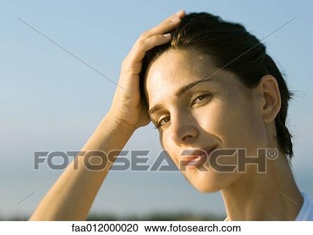 Woman with hand on bead, portrait View Large Photo Image Stock Image - Woman with hand on bead, portrait. Fotosearch