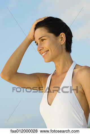 Woman with hand on head, portrait View Large Photo Image Stock Photo - Woman with hand on head, portrait. Fotosearch