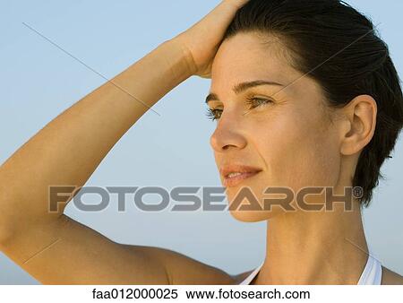 Woman with hand on head, portrait View Large Photo Image Stock Photography - Woman with hand on head, portrait. Fotosearch