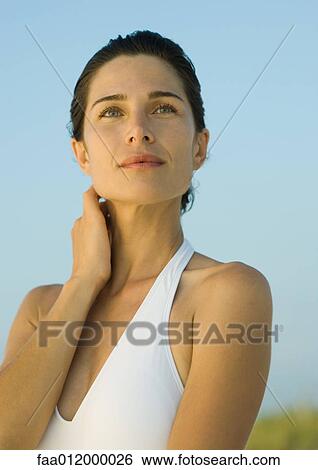 Woman with hand on neck, portrait View Large Photo Image Stock Photograph - Woman with hand on neck, portrait. Fotosearch