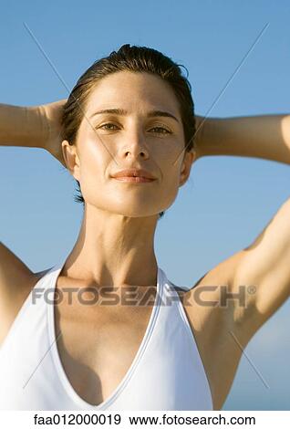 Woman with hands behind head, portrait View Large Photo Image Stock Photo - Woman with hands behind head, portrait. Fotosearch