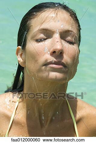 Woman's wet face, close-up, water in background View Large Photo Image Stock Image - Woman's wet face, close-up, water in background. Fotosearch