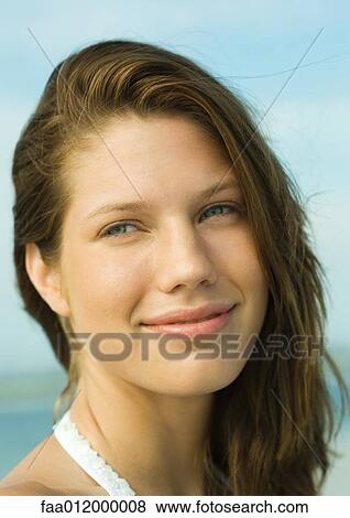 Stock Photo - Young woman smiling, portrait. Fotosearch