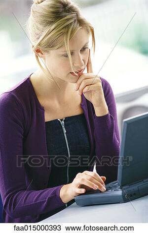 Young woman using laptop View Large Photo Image Stock Image - Young woman using laptop. Fotosearch