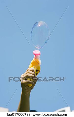 Boy making bubbles with bubble gun View Large Photo Image Stock Image - Boy making bubbles with bubble gun. Fotosearch