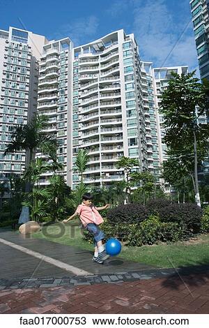 Boy playing ball in apartment complex View Large Photo Image Stock Image - Boy playing ball in apartment complex. Fotosearch