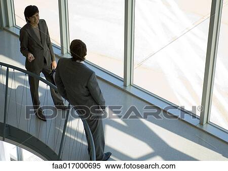 Business associates chatting, high angle view View Large Photo Image Stock Photography - Business associates chatting, high angle view. Fotosearch