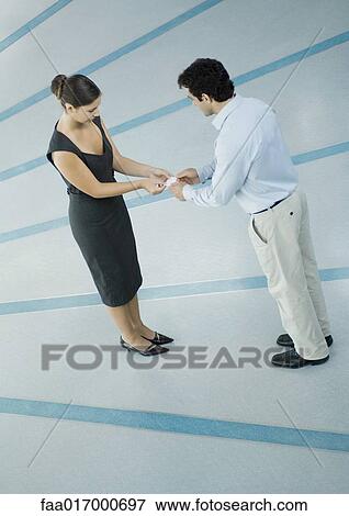 Stock Photo - Business associates exchanging business cards. Fotosearch