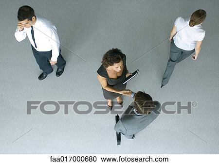 Business associates shaking hands, high angle view View Large Photo Image Stock Image - Business associates shaking hands, high angle view. Fotosearch