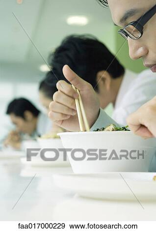 Business executives eating in cafeteria View Large Photo Image Stock Photo - Business executives eating in cafeteria. Fotosearch
