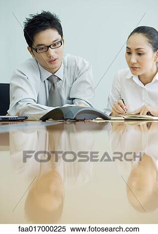 Stock Photography - Business executives working in conference room. Fotosearch