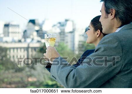 Business partners holding up glasses of champagne, skyline in background View Large Photo Image Stock Image - Business partners holding up glasses of champagne, skyline in background. Fotosearch