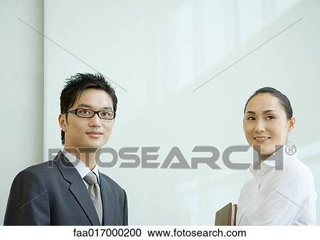Businessman and businesswoman looking away, smiling, head and shoulders View Large Photo Image Stock Image - Businessman and businesswoman looking away, smiling, head and shoulders. Fotosearch
