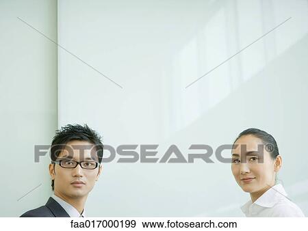 Businessman and businesswoman looking at camera, head and shoulders View Large Photo Image Stock Photo - Businessman and businesswoman looking at camera, head and shoulders. Fotosearch
