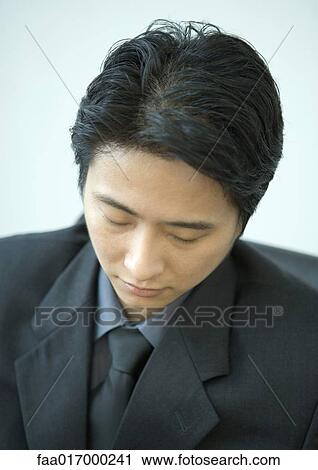 Businessman, eyes closed, high angle view View Large Photo Image Stock Image - Businessman, eyes closed, high angle view. Fotosearch