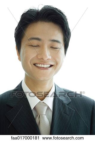 Stock Image - Businessman, eyes shut, portrait. Fotosearch