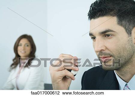 Stock Image - Businessman holding stress ball. Fotosearch