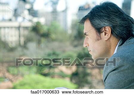 Businessman looking out over city, side view View Large Photo Image Stock Image - Businessman looking out over city, side view. Fotosearch