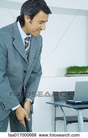 Stock Photo - Businessman putting in office. Fotosearch