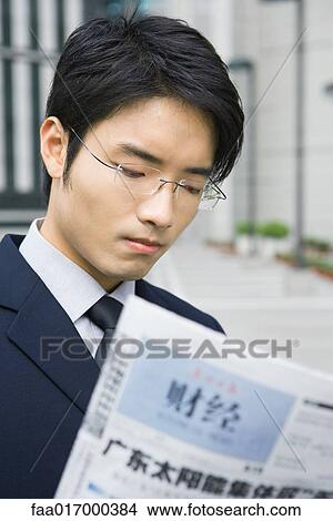 Businessman reading Chinese newspaper View Large Photo Image Picture - Businessman reading Chinese newspaper. Fotosearch