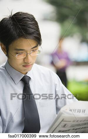 Businessman reading newspaper View Large Photo Image Stock Photo - Businessman reading newspaper. Fotosearch