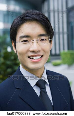 Businessman smiling at camera, portrait View Large Photo Image Stock Photo - Businessman smiling at camera, portrait. Fotosearch