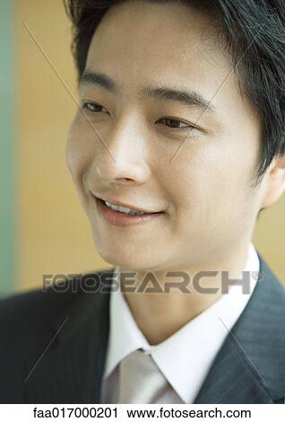 Stock Image - Businessman smiling, close-up, portrait. Fotosearch