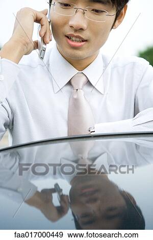 Stock Photo - Businessman using cell phone. Fotosearch