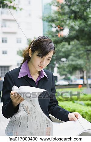 Businesswoman reading newspaper View Large Photo Image Stock Image - Businesswoman reading newspaper. Fotosearch