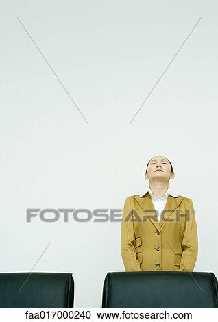 Businesswoman standing with eyes shut and head back View Large Photo Image Stock Image - Businesswoman standing with eyes shut and head back. Fotosearch