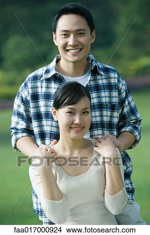 Couple, man with hands on woman's shoulders, portrait View Large Photo Image Picture - Couple, man with hands on woman's shoulders, portrait. Fotosearch