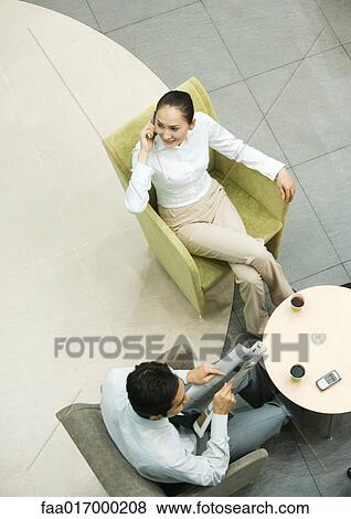 Stock Photo - Executives sitting in lobby, high angle view. Fotosearch