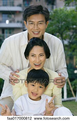 Stock Image - Family, smiling at camera, portrait. Fotosearch