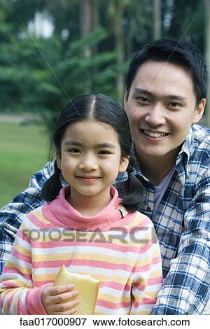 Father and daughter, girl holding slice of bread, portrait View Large Photo Image Stock Photo - Father and daughter, girl holding slice of bread, portrait. Fotosearch