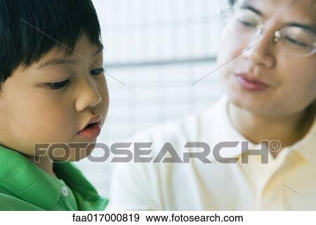 Father and son, boy looking down, man looking at boy View Large Photo Image Stock Photo - Father and son, boy looking down, man looking at boy. Fotosearch
