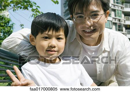 Father and son, boy making "v" sign with fingers View Large Photo Image Stock Photography - Father and son, boy making "v" sign with fingers. Fotosearch