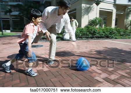 Father and son playing ball, blurred motion View Large Photo Image Stock Image - Father and son playing ball, blurred motion. Fotosearch