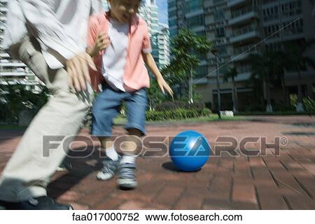 Father and son playing ball, blurred motion View Large Photo Image Stock Image - Father and son playing ball, blurred motion. Fotosearch
