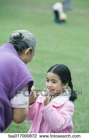 Girl with grandmother, playing clapping game View Large Photo Image Stock Image - Girl with grandmother, playing clapping game. Fotosearch