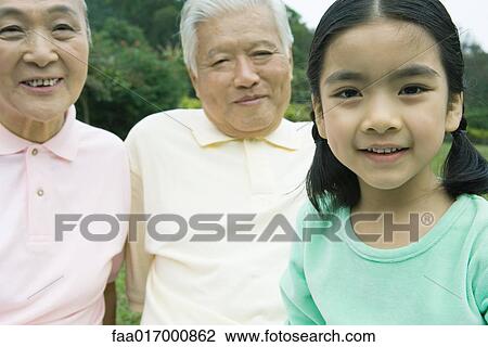 Stock Image - Girl with grandparents, portrait. Fotosearch