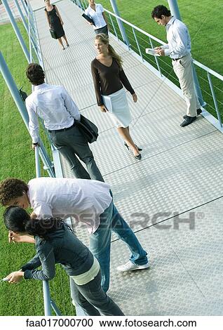 Group of people involved in different activities on walkway View Large Photo Image Stock Image - Group of people involved in different activities on walkway. Fotosearch