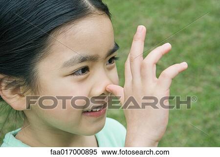 Stock Photography - Little girl thumbing nose, close-up. Fotosearch