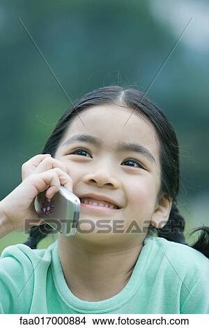 Little girl using cell phone, close-up View Large Photo Image Picture - Little girl using cell phone, close-up. Fotosearch